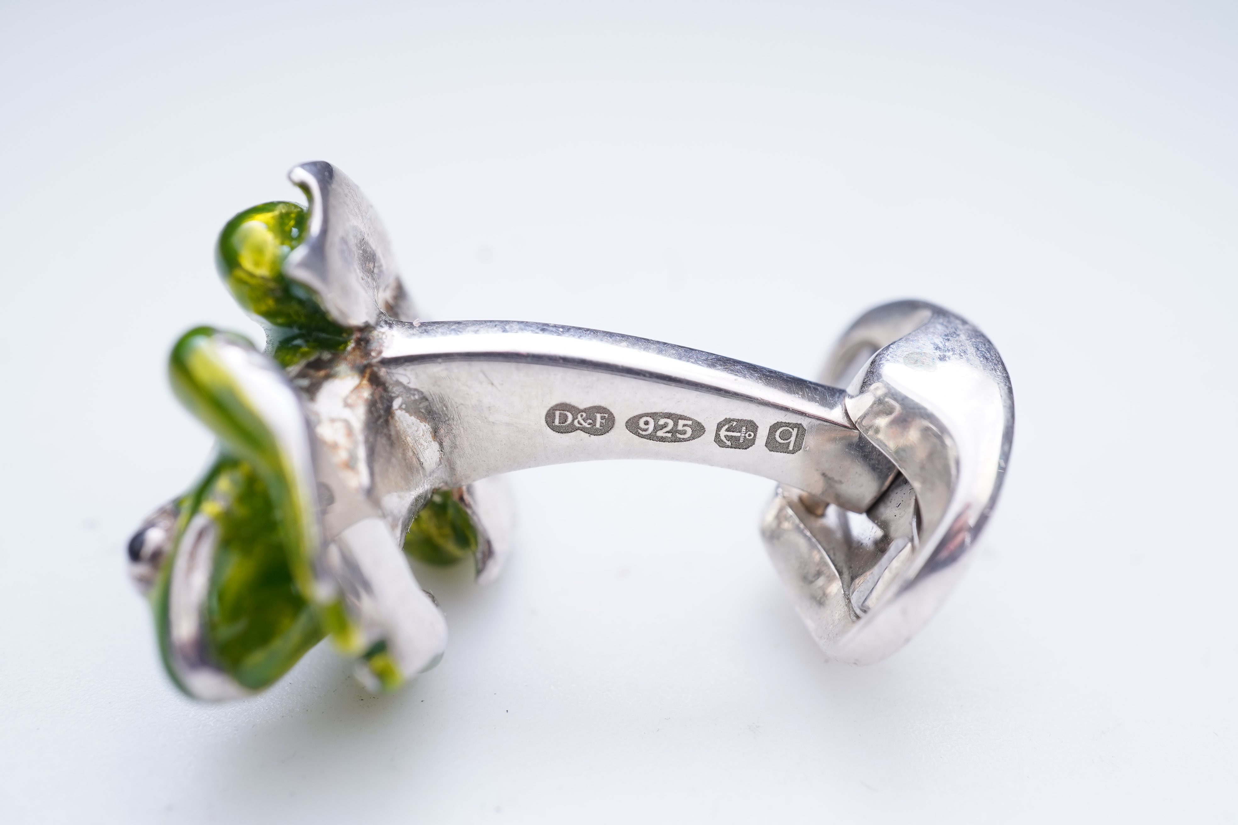 A modern pair of silver and polychrome enamel set oval cufflinks, 18mm.